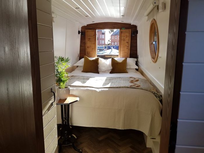 An interior designed narrow boat bedroom